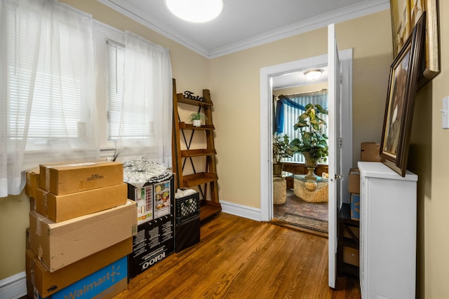 interior space with hardwood / wood-style floors, ornamental molding, and a baseboard heating unit