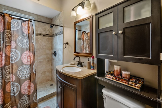 bathroom featuring tile patterned flooring, vanity, curtained shower, and toilet