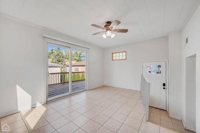 tiled spare room featuring ceiling fan and ornamental molding