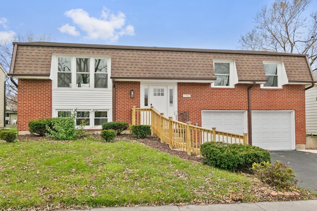 tri-level home with a garage and a front yard