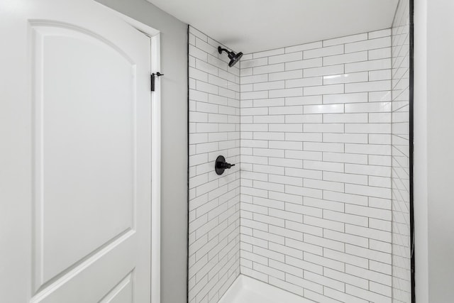 bathroom with a tile shower