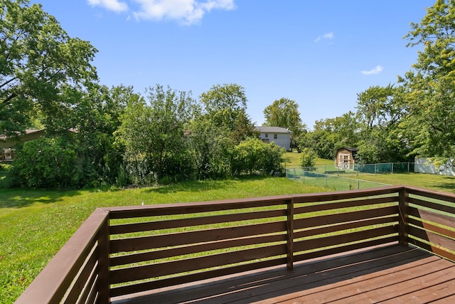 wooden terrace featuring a lawn