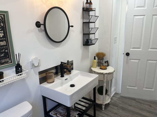 bathroom featuring sink, hardwood / wood-style floors, and toilet