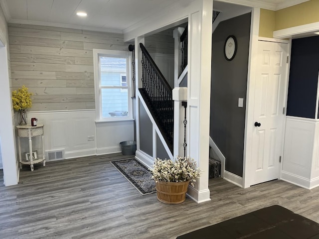 interior space with wood-type flooring and crown molding