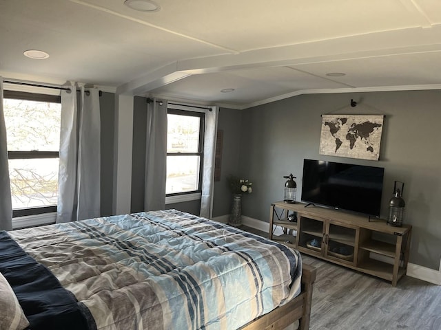 bedroom with crown molding and hardwood / wood-style flooring