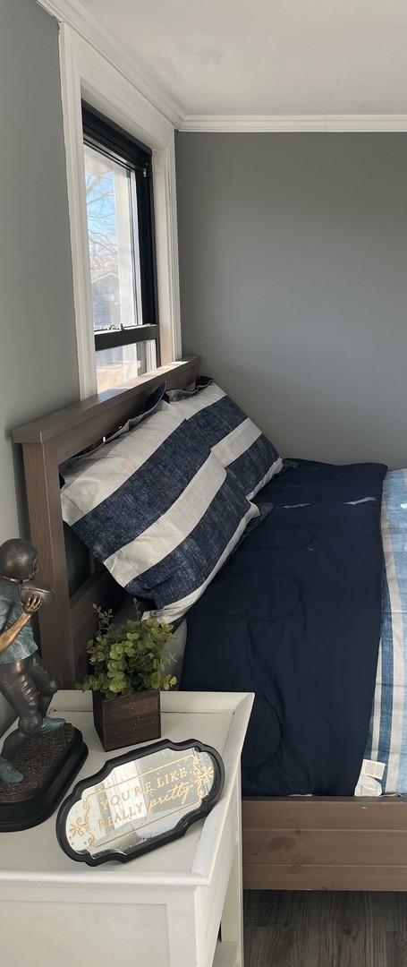 bedroom with ornamental molding