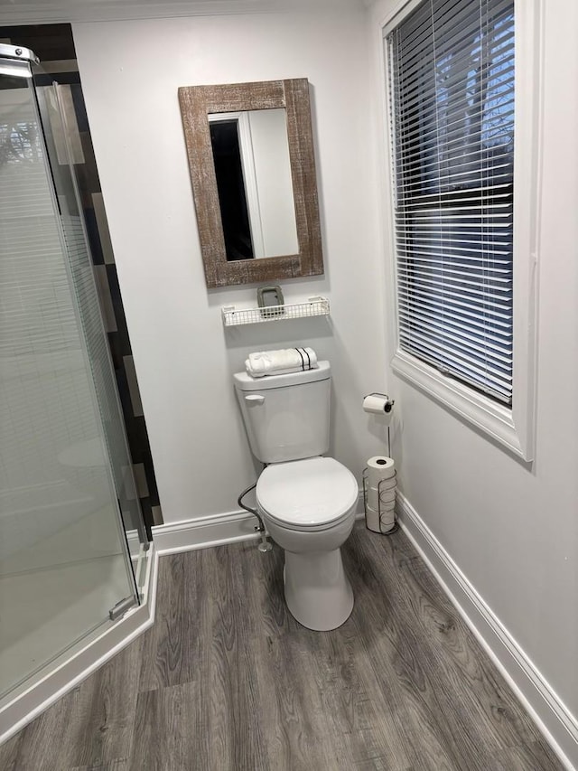 bathroom featuring hardwood / wood-style floors, toilet, and walk in shower