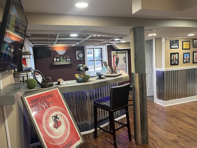 bar with dark hardwood / wood-style flooring