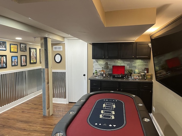 interior space featuring wood-type flooring and tasteful backsplash