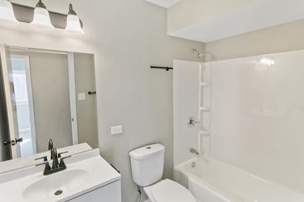 full bathroom with vanity, toilet, and shower / washtub combination