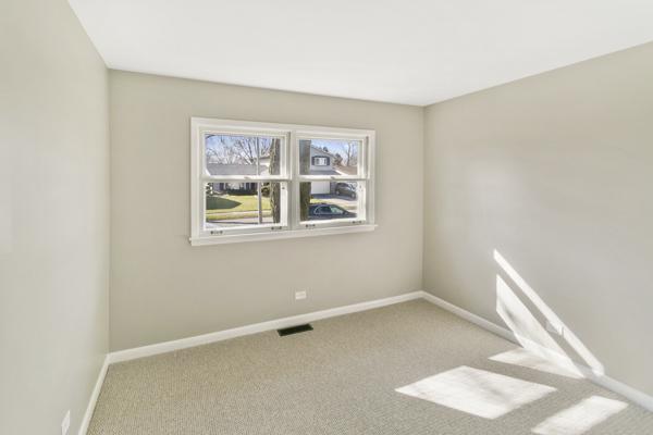 unfurnished room with light colored carpet