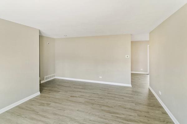 unfurnished room with hardwood / wood-style flooring