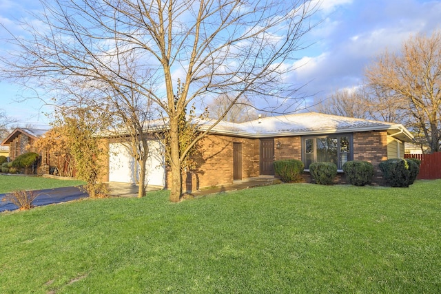 single story home featuring a front yard and a garage