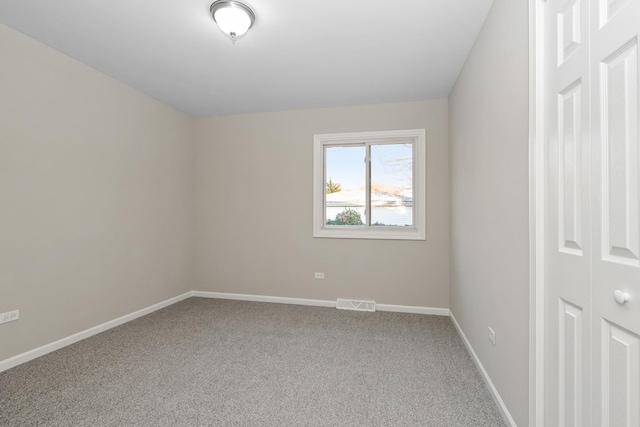 unfurnished room featuring carpet flooring