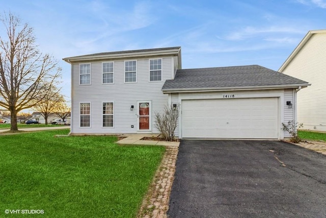 view of front of home with a garage and a front yard