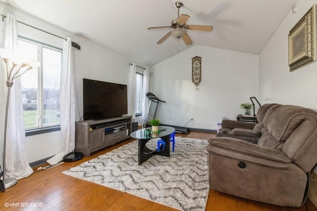 living room featuring wood-type flooring, vaulted ceiling, and ceiling fan