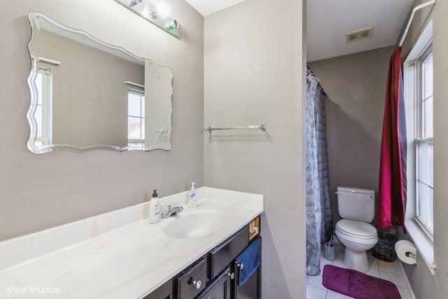 bathroom with vanity, toilet, tile patterned flooring, and plenty of natural light