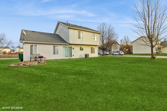 rear view of house featuring a lawn