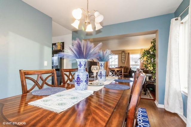 dining room featuring dark hardwood / wood-style flooring and a chandelier