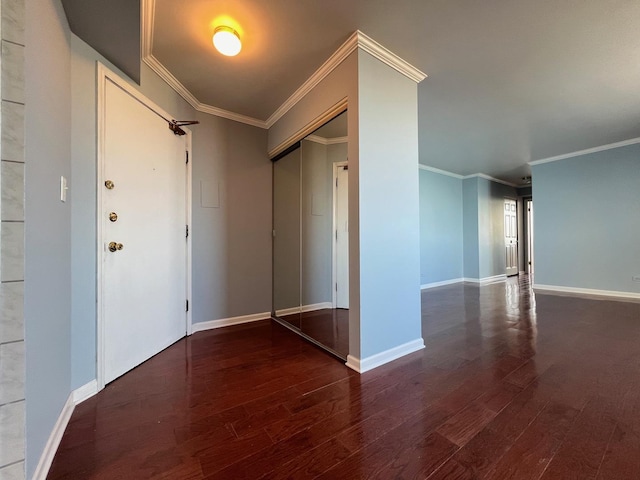 spare room featuring crown molding and dark wood-type flooring