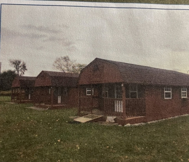 exterior space with covered porch and a lawn