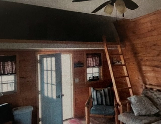 living area featuring a ceiling fan