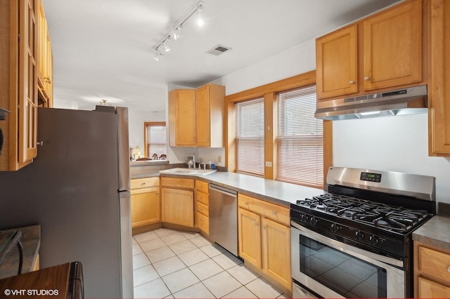 kitchen featuring sink, stainless steel appliances, and light tile patterned flooring