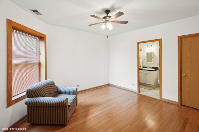 sitting room with ceiling fan, sink, and light hardwood / wood-style flooring