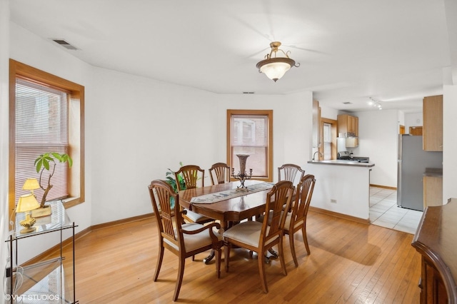 dining area featuring light wood-type flooring