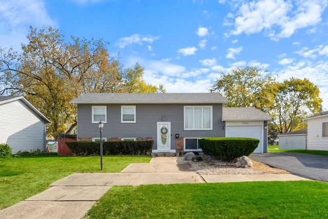 raised ranch with a garage and a front yard