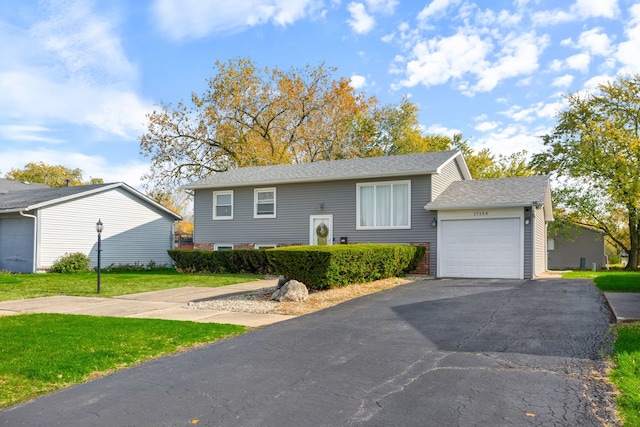 bi-level home featuring a garage and a front yard