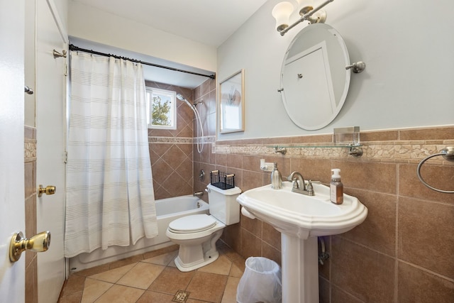 full bathroom featuring tile patterned flooring, shower / bath combo, toilet, and tile walls