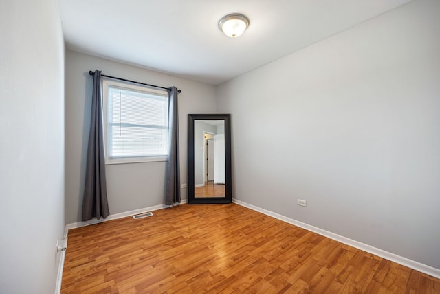 spare room featuring light wood-type flooring