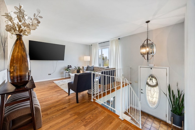 entryway with hardwood / wood-style flooring and a notable chandelier