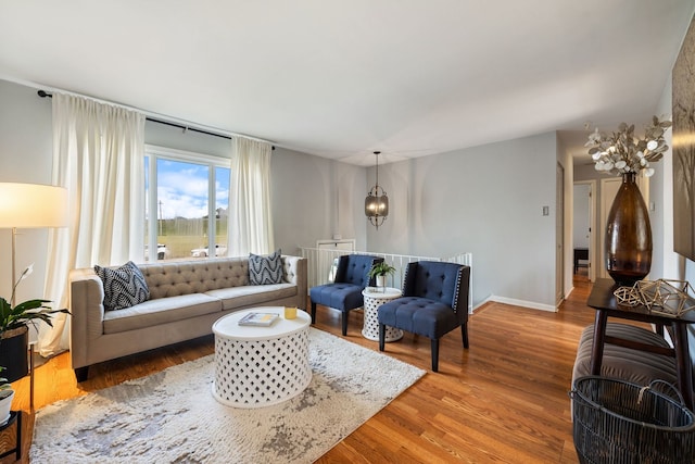 living room with hardwood / wood-style floors and an inviting chandelier