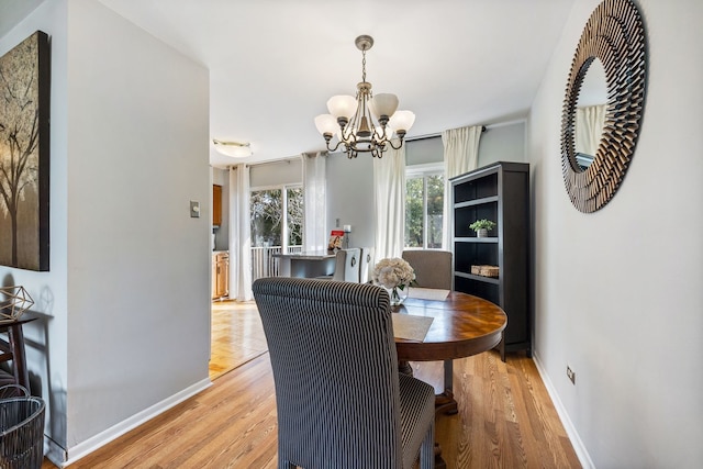 dining area featuring a chandelier and light hardwood / wood-style floors