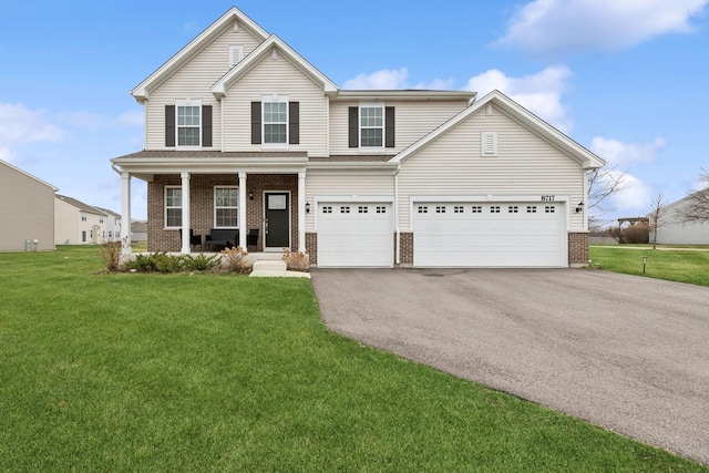 front of property with a garage, a porch, and a front yard