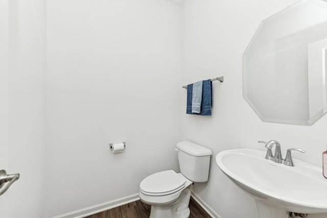 bathroom featuring hardwood / wood-style floors, toilet, and sink