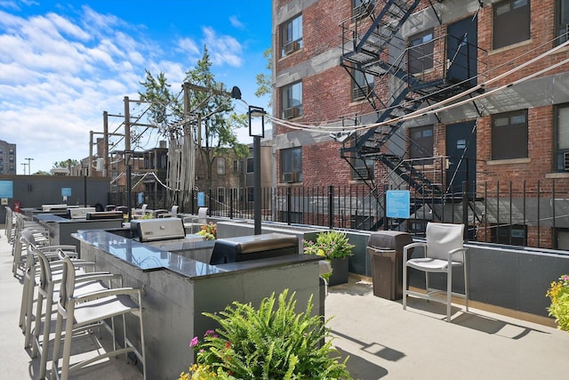 view of patio / terrace featuring area for grilling and a bar