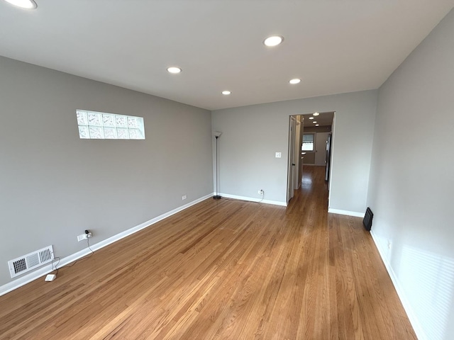 unfurnished room featuring light hardwood / wood-style floors and plenty of natural light