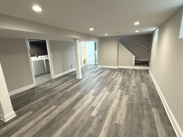 basement with washing machine and dryer and dark hardwood / wood-style floors