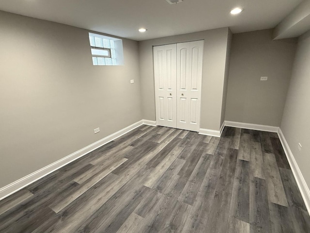 basement featuring dark hardwood / wood-style flooring