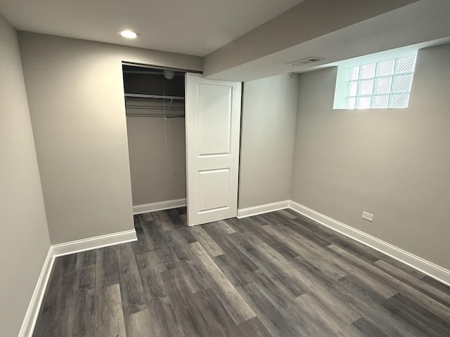 unfurnished bedroom featuring dark wood-type flooring and a closet