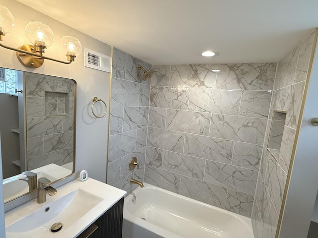 bathroom with vanity and tiled shower / bath