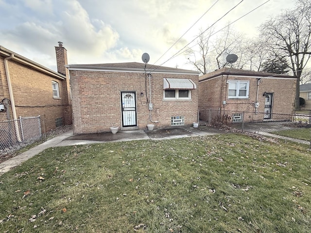 rear view of property featuring a yard