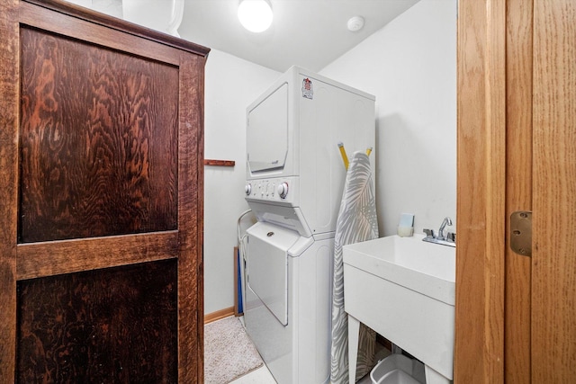 laundry area with sink and stacked washer and dryer