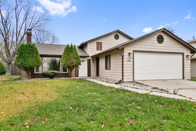 view of front of home featuring a garage and a front yard