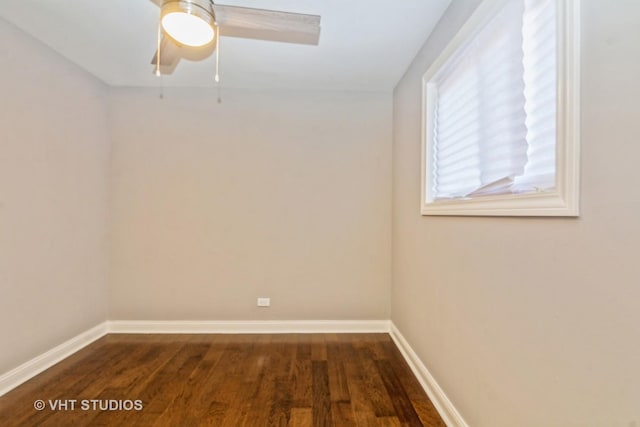 empty room with baseboards, dark wood-type flooring, and a ceiling fan