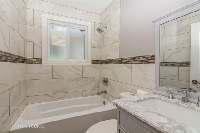 full bath with vanity, tile walls, toilet, and shower / bath combination