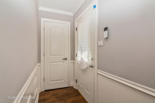 entryway with dark wood-type flooring and ornamental molding